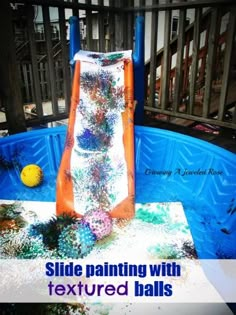 a slide painted with textured balls in an above ground pool