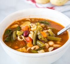 a white bowl filled with soup and vegetables