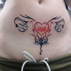 a woman's stomach with tattoos on it