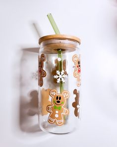 there is a glass jar with some stickers on it and a straw sticking out of it