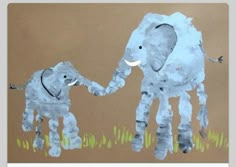 a child's drawing of an elephant and baby elephant on brown paper with grass