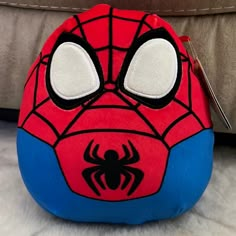 a spiderman pillow sitting on top of a table