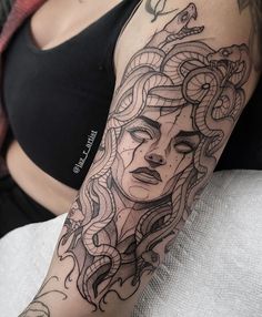 a woman with a snake tattoo on her arm