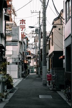 an alley way with lots of buildings and power lines