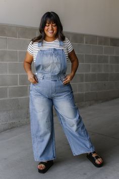 Calling all cool cats (and kittens)! These denim overalls are your new outfit BFF. They've got adjustable shoulder straps for the perfect fit, and classic pockets in the front and back to stash your essentials (hello, phone!). The barrel legs are relaxed and comfy, with a slouchy vibe that's effortlessly cool. Made from a medium wash denim, they're a wardrobe staple that goes with everything. Dress them up with a blouse or keep it casual with a tee - these overalls are ready for anything! Denim overalls Adjustable shoulder straps Classic front & back pockets Barrel leg Slouchy relaxed fit Medium wash 100% Cotton Fit and sizing:  Measurements are approximate. Length measurements are taken from the top of the shoulder to the bottom hem lying flat. Small - Waist: 30", Inseam: 27" Medium - Wai Casual Denim Blue Overalls With Adjustable Straps, Medium Wash Denim Overalls With Adjustable Straps, Trendy Denim Jumpsuit With Adjustable Straps, Casual Jeans Overalls With Adjustable Straps, Casual Denim Jeans With Adjustable Straps, Casual Denim Blue Jeans With Adjustable Straps, Denim Overalls With Adjustable Straps In Dark Wash, Dark Wash Denim Overalls With Adjustable Straps, Relaxed Fit Medium Wash Overalls With Adjustable Straps