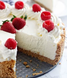 a cake with white frosting and raspberries on top