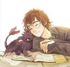 a young man laying on the floor next to an open book while holding a dragon