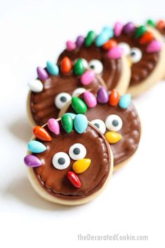 decorated cookies with chocolate frosting and colored decorations on them are arranged in the shape of turkeys