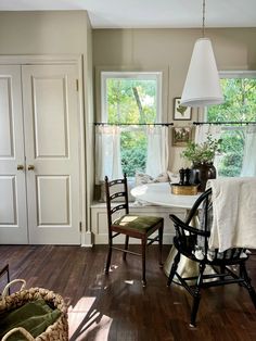 a dining room table and chairs in front of a window