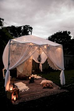 a white tent with some lights on it