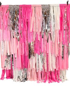 pink and white dresses hanging on a rack with sequins in the back ground