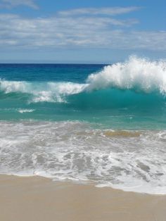 the ocean waves are crashing on the beach