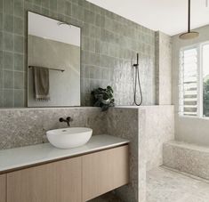 a bathroom with a sink, mirror and bathtub