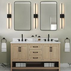 a bathroom vanity with two mirrors above it