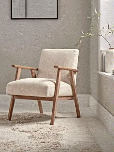 a white chair sitting in front of a window on top of a carpeted floor