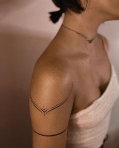 a woman with a tattoo on her shoulder