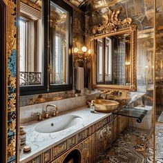 a fancy bathroom with gold and black decor on the walls, marble counter tops and sinks