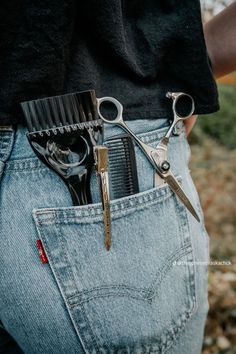 scissors and combs are in the pocket of someone's jeans