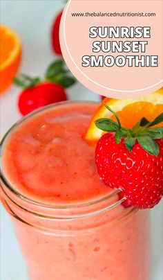 a smoothie in a mason jar with strawberries and oranges on the side