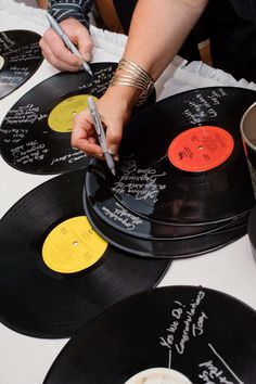 a person is writing on some old records