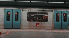 an empty subway car with its doors open and people standing on the platform next to it