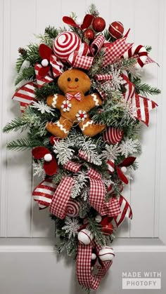 a christmas wreath with a teddy bear and candy canes