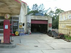 an old gas station has been converted into a storage area for cars and other junk