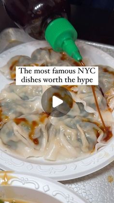 the most famous nyc dishes worth the hype are on this white plate with sauce being drizzled over them