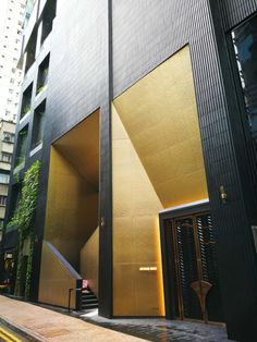 the entrance to an apartment building with gold foil covering it's doors and windows