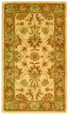 a rug with an ornate design on the front and back side, in green tones