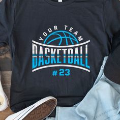 a t - shirt that says your team basketball 23 on it next to some shoes