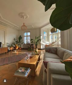 a living room filled with furniture and lots of plants