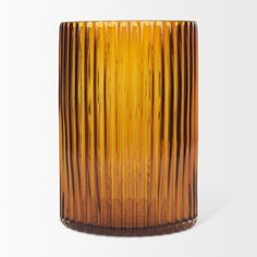 an orange glass vase sitting on top of a white table