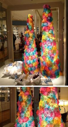 two pictures of colorful umbrellas in the middle of a store window and one is made out of tissue paper