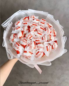 a bowl filled with candy sitting on top of a table