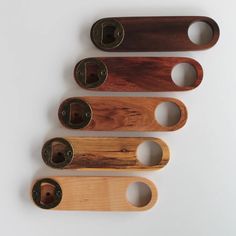 four wooden handles with holes in them