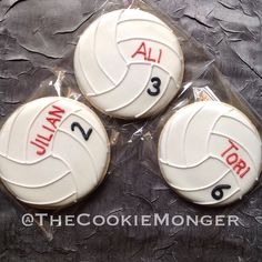 three decorated cookies in the shape of volleyball balls