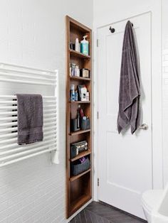 a bathroom with a towel rack next to the door