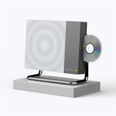 a computer monitor with a disc on top of it's stand, in front of a white background