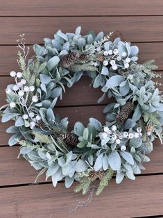 enchanting lamb's ear wreath combines soft, silvery greenery with the rich textures of the This holiday season. The wreath is crafted with lush lamb's ear leaves that lend a velvety, silvery tone, while the vibrant white sparkling berries add a touch of winter magic. Intertwined with Forster mixed pine, the wreath exudes a natural, rustic charm, enhanced by adding pinecones that bring a cozy woodland feel. Perfect for decorating doors, mantels, or windows, this wreath evokes the serene beauty of