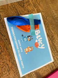 a blue and orange ribbon on top of a piece of paper