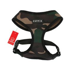 a black and green camo dog harness with the word puppa on it's chest