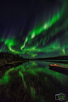 an aurora bore is seen over the water in this green and black night time photo