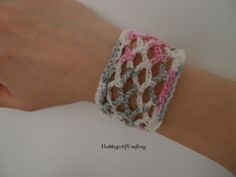 a woman's arm with a crocheted bracelet on it