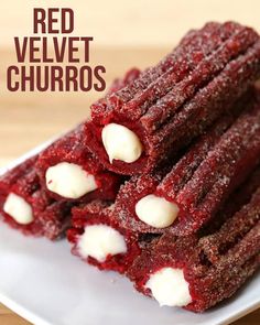 red velvet churros are stacked on a plate