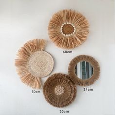 three round straw mirrors hanging on the wall next to each other with different shapes and sizes