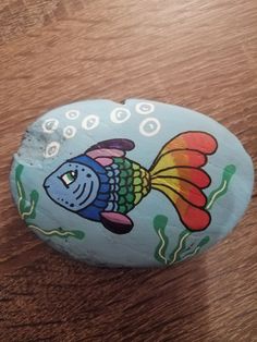 a painted rock with a fish on it