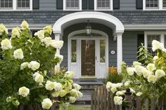 a house with white flowers in front of it