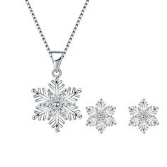 Capture the enchantment of a winter wonderland with our Austrian Crystal Bridal Snowflake Necklace & Earrings Set in clear silver-tone. Designed to evoke the ethereal beauty of freshly fallen snow, this set exudes timeless elegance and sophistication. Each piece is meticulously adorned with shimmering Austrian crystals, meticulously arranged to form delicate snowflake motifs. The clear crystals sparkle like ice in the sunlight, casting a spellbinding aura that captivates all who behold them. The necklace, suspended from a graceful silver-tone chain, drapes elegantly around the neck, drawing attention to its intricate craftsmanship and radiant allure. Paired with matching earrings, these pieces create a harmonious ensemble that complements any bridal gown or formal attire. Whether worn on y Wood Inlay Rings, Snowflake Necklace, Crystal Snowflakes, Snowflake Pendant, Sterling Silver Stud Earrings, Earrings Crystal, Ring Pendant Necklace, Engagement Ring Wedding Band, Austrian Crystal