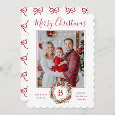 a merry christmas card with a family holding a baby